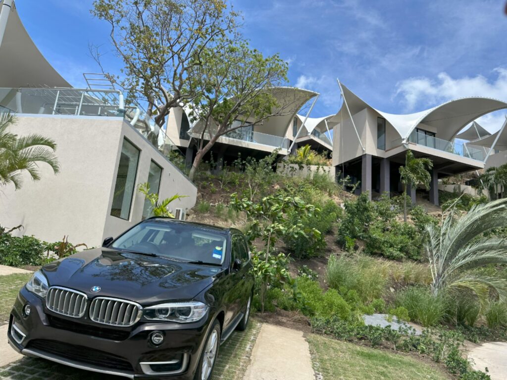 A private car with a resort in Grenada in the background